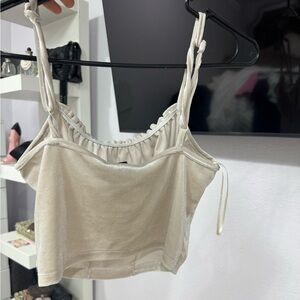 This is a super cute spaghetti strap.The color is a silver some what gold tone